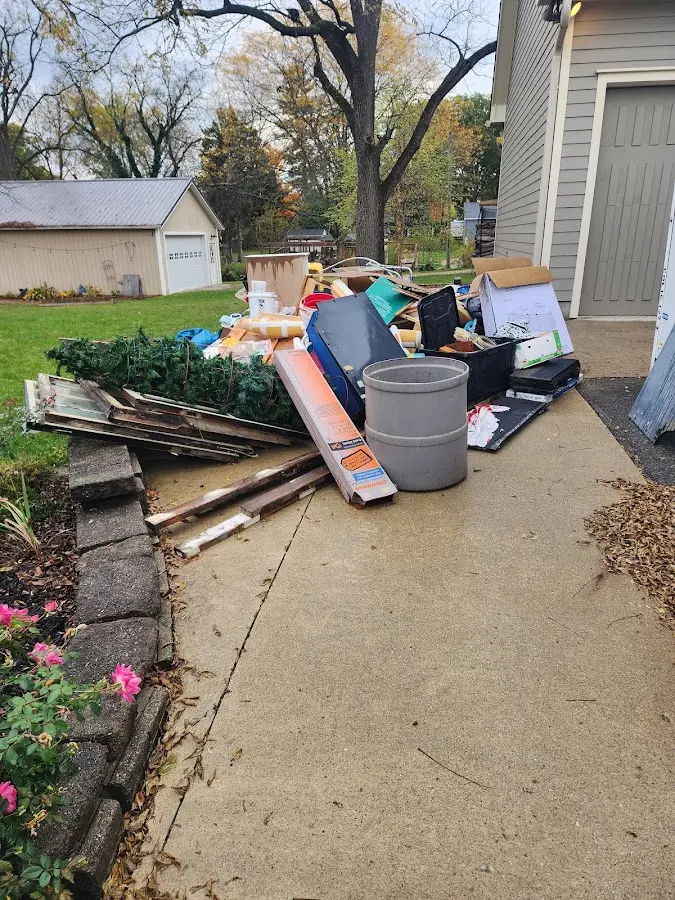 Dumpster being loaded with debris for 3 Yard Dumpster Rental in Belterra